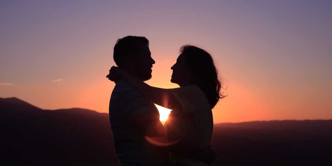 silhouette of hugging couple